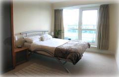 Master bedroom in a three bedroom apartment