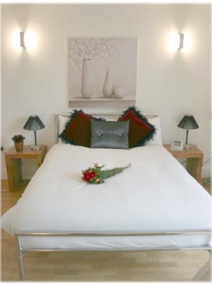 Bed in a KSpace studio apartment